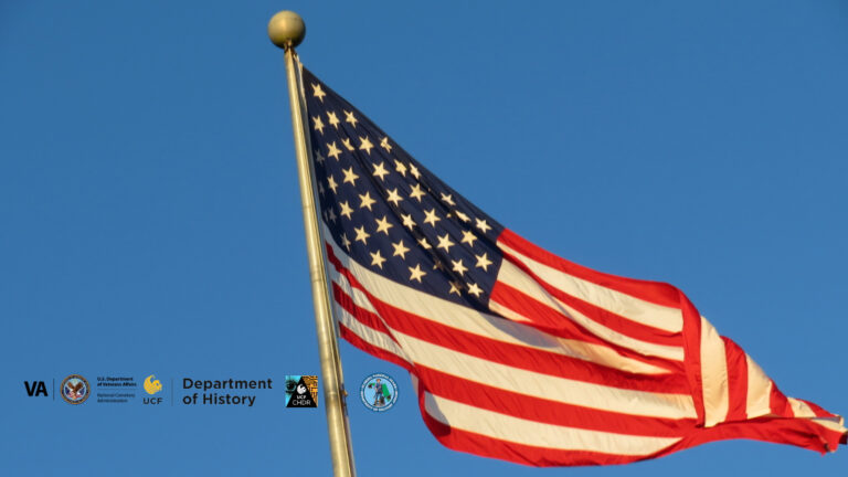 American flag waving on a tall flagpole against a clear blue sky. Emblems representing various supporting organizations are displayed in the lower left corner: the US Department of Veterans Affairs, National Cemetery Administration, University of Central Florida, UCF Department of History, UCF Center for Humanities and Digital Research, and the Florida National Guard.