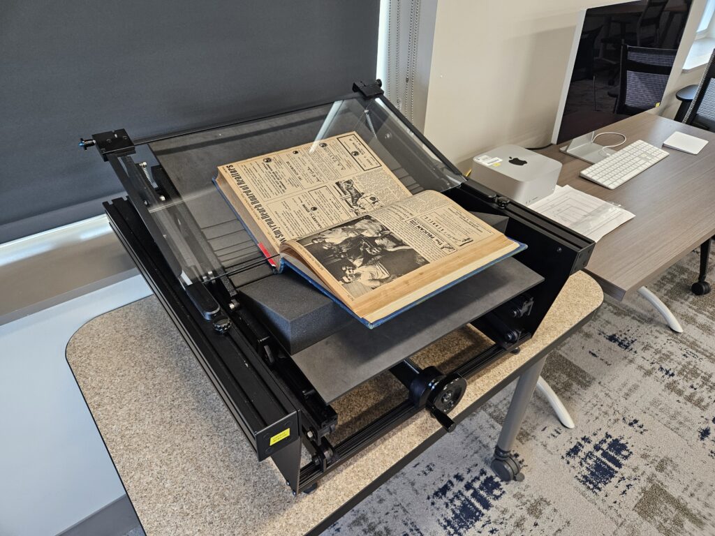 A book cradle for holding books in place while scanning them for archival purposes. The cradle possesses a bed for laying the book against, a glass pane for holding the relevant section down while leaving it transparent to the camera, and foam to position the book comfortably against the bed.